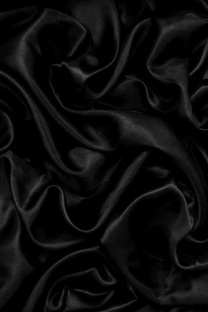 a black background with a very large amount of fabric