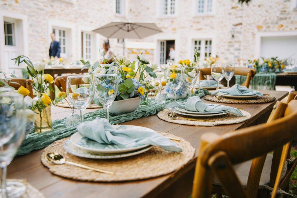 Outdoor table setting with floral decorations and place settings